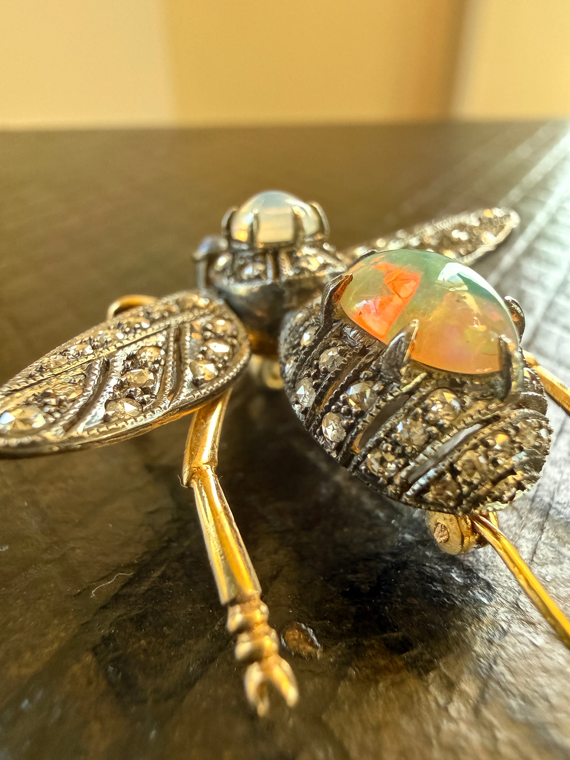 That wonderful opal fire!  Plus, check out the little details on his little legs!