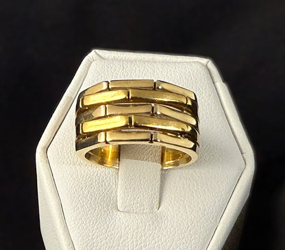 Front view of chunky 18k yellow and white gold band ring with five raised alternating geometric segments