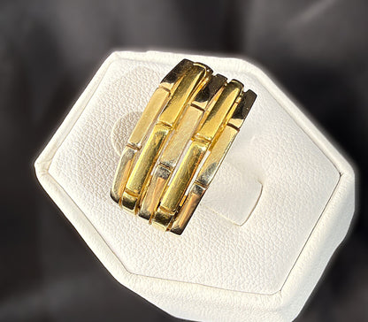 Angled top view of 18k two-tone gold ridged band ring showing its sculptural raised segments and alternating yellow and white gold