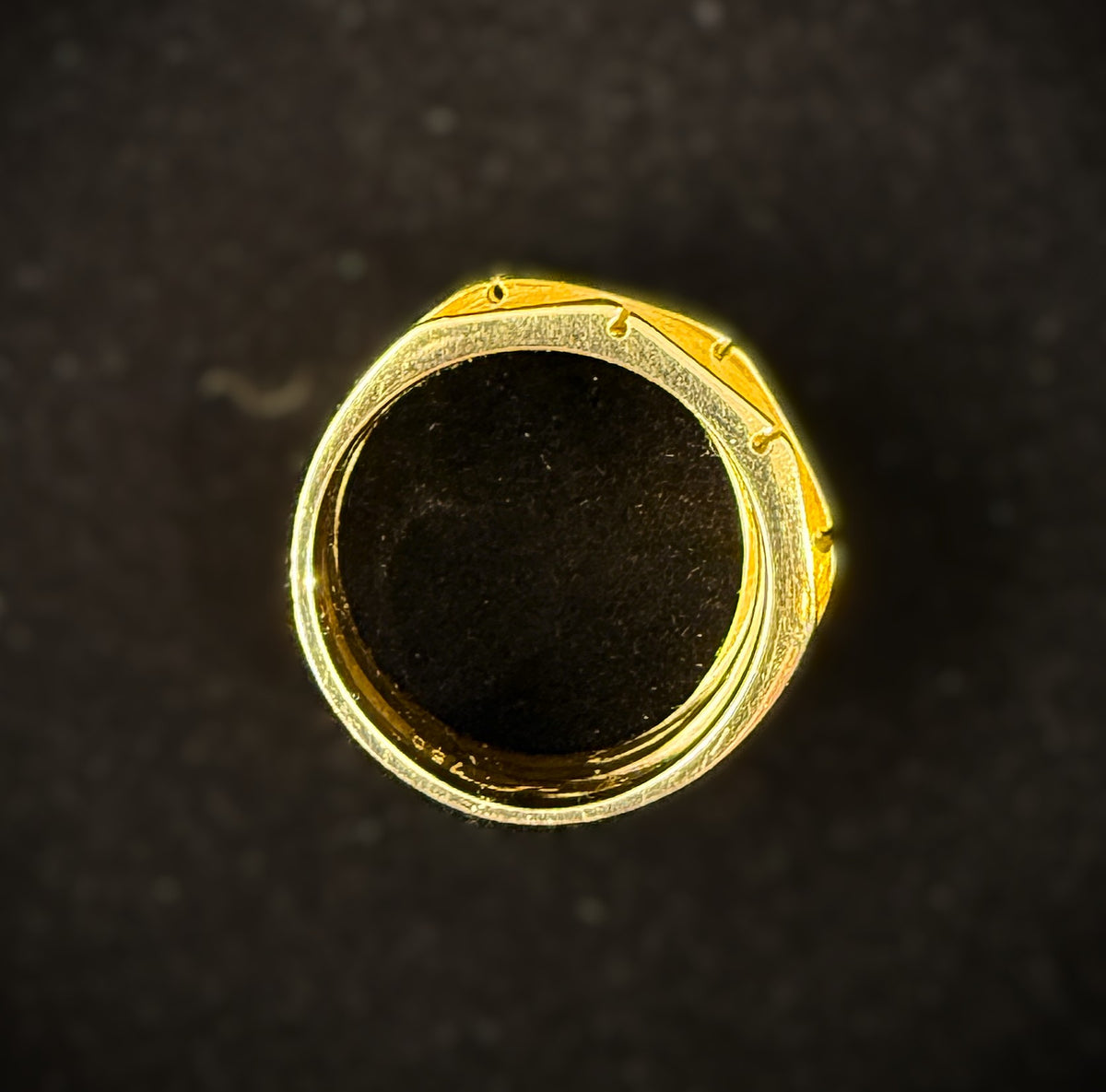 Side profile of 18k two-tone gold band ring highlighting the graduated height and architectural ridged design