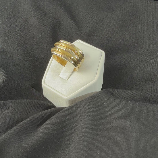 movie video of a heafty 18k yellow and white gold band ring with five raised alternating geometric segments