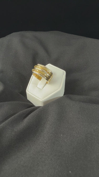 movie video of a heafty 18k yellow and white gold band ring with five raised alternating geometric segments