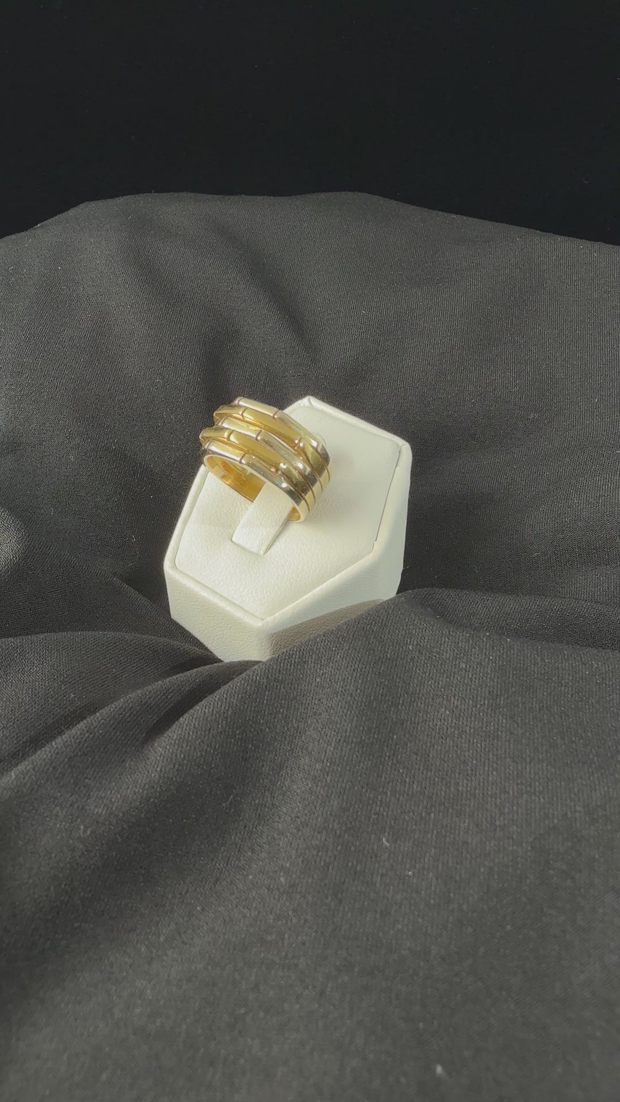 movie video of a heafty 18k yellow and white gold band ring with five raised alternating geometric segments